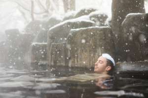 Man relaxing in Ryokan hot spring spa in Winter