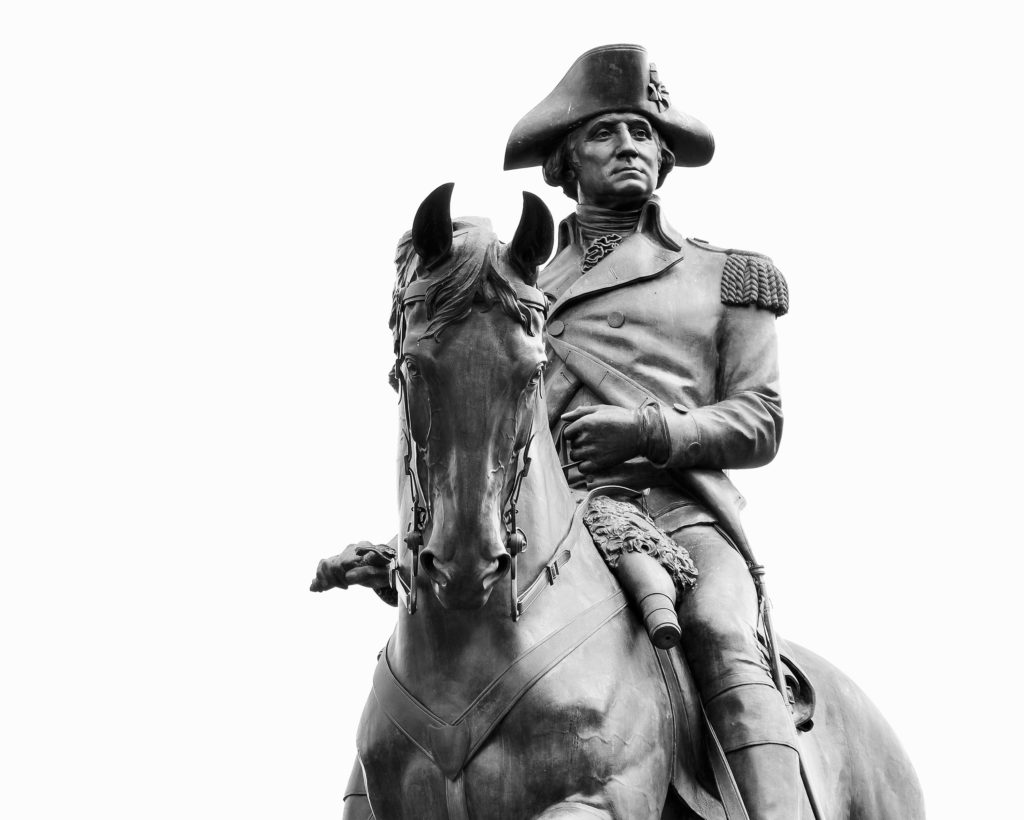 This statue of George Washington stands regally in the Public Garden in Boston, Massachusetts. It is located at the Arlington Street gate which faces Commonwealth Avenue, and was sculpted by Thomas Ball in 1869.
