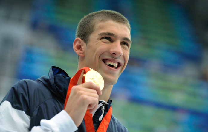 Image: Phelps of the U.S. with his gold medal for the men's 200m freestyle final at the Beijing 2008 Olympic Games decorated olympians