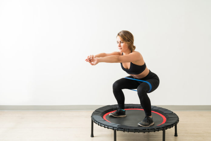 Full Length Of Young Caucasian Woman Exercising At Studio