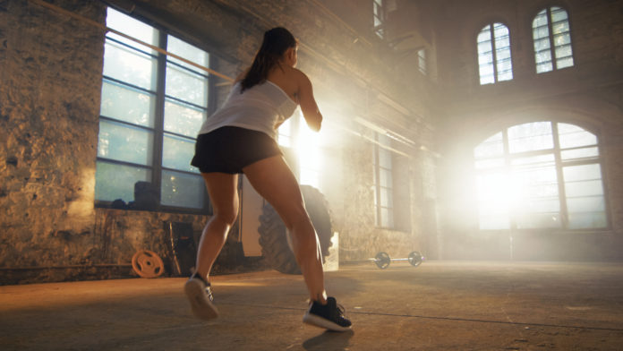 Fit Athletic Woman Does Footwork Running Drill in a Deserted Factory Remodeled into Gym. Cross Fitness Exercise/ Workout Aimed at Strengthening Legs, Enhancing Her Agility and Speed.